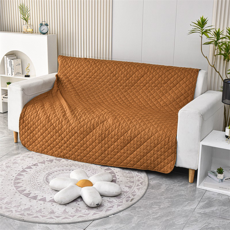 A senior dog's couch protected by a waterproof bed cover